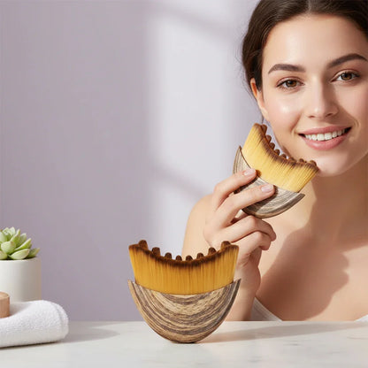 Woman smiling holding wooden facial brush with soft bristles, skincare product on table