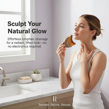 Woman using facial massage tool for lymphatic drainage in bright bathroom